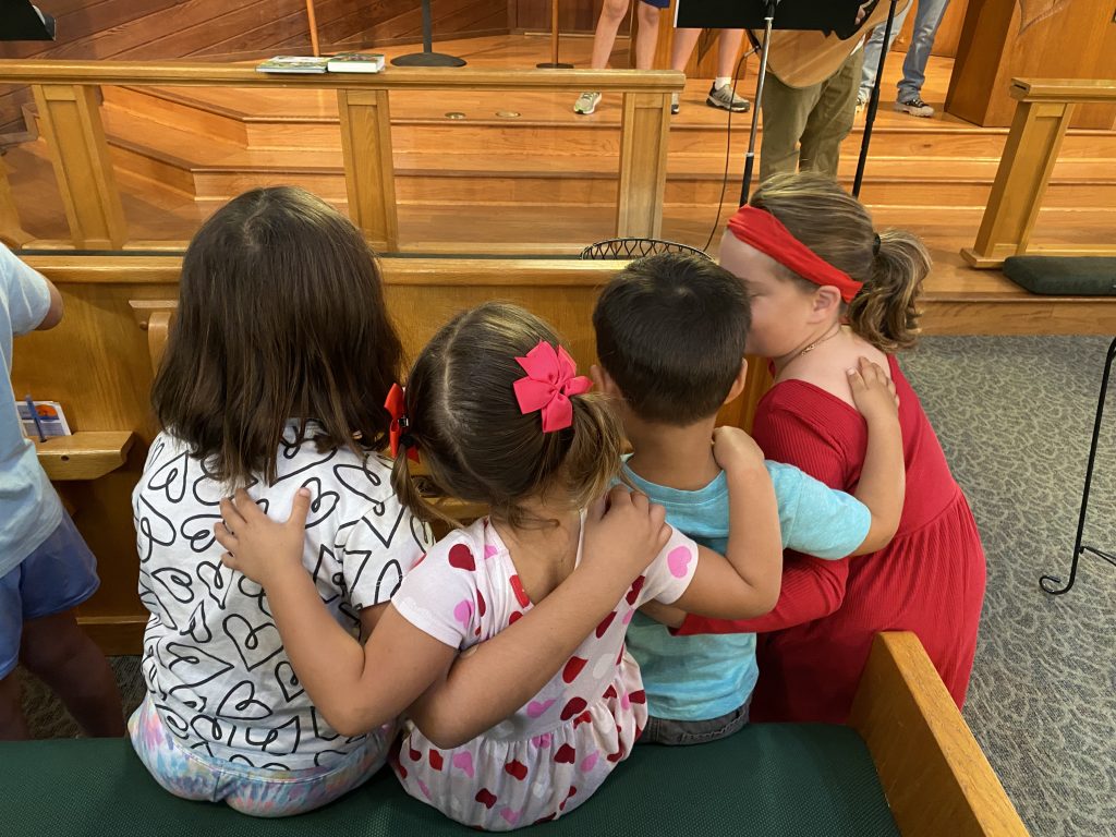 Students embrace during whole-campus chapel, which takes place at St. Paul School once a month