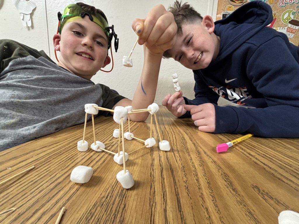 Students practice engineering skills with marshmallows and toothpicks.