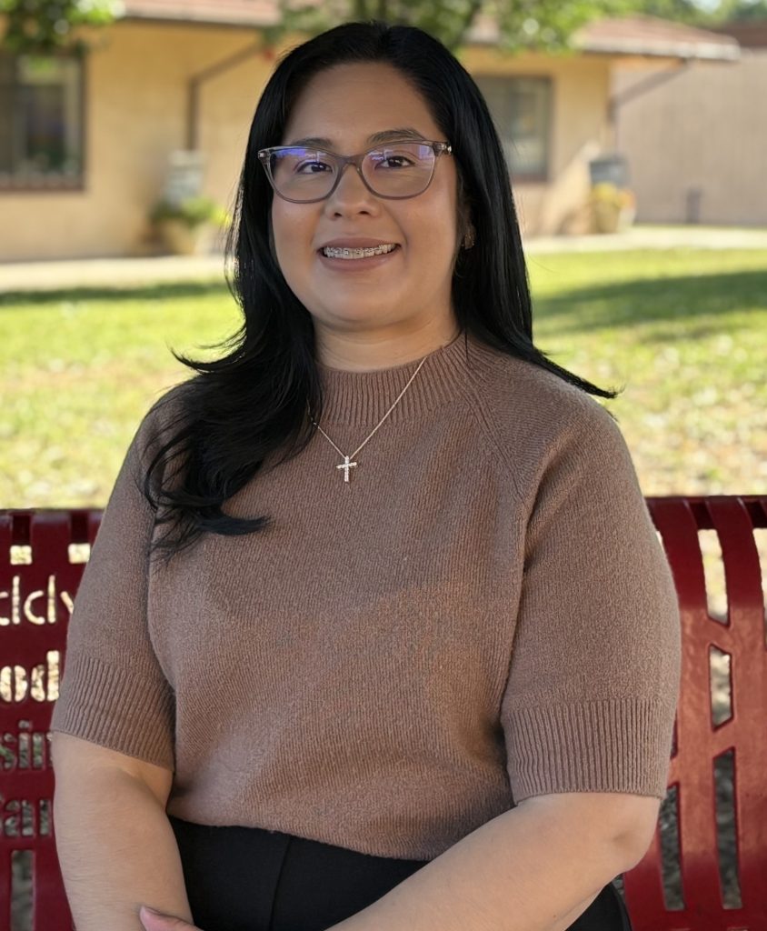 Adilene Villegas sits on the buddy bench at St. Paul Elementary School. The bench was donated by Dr. Andy Propes, a longtime supporter of our school.